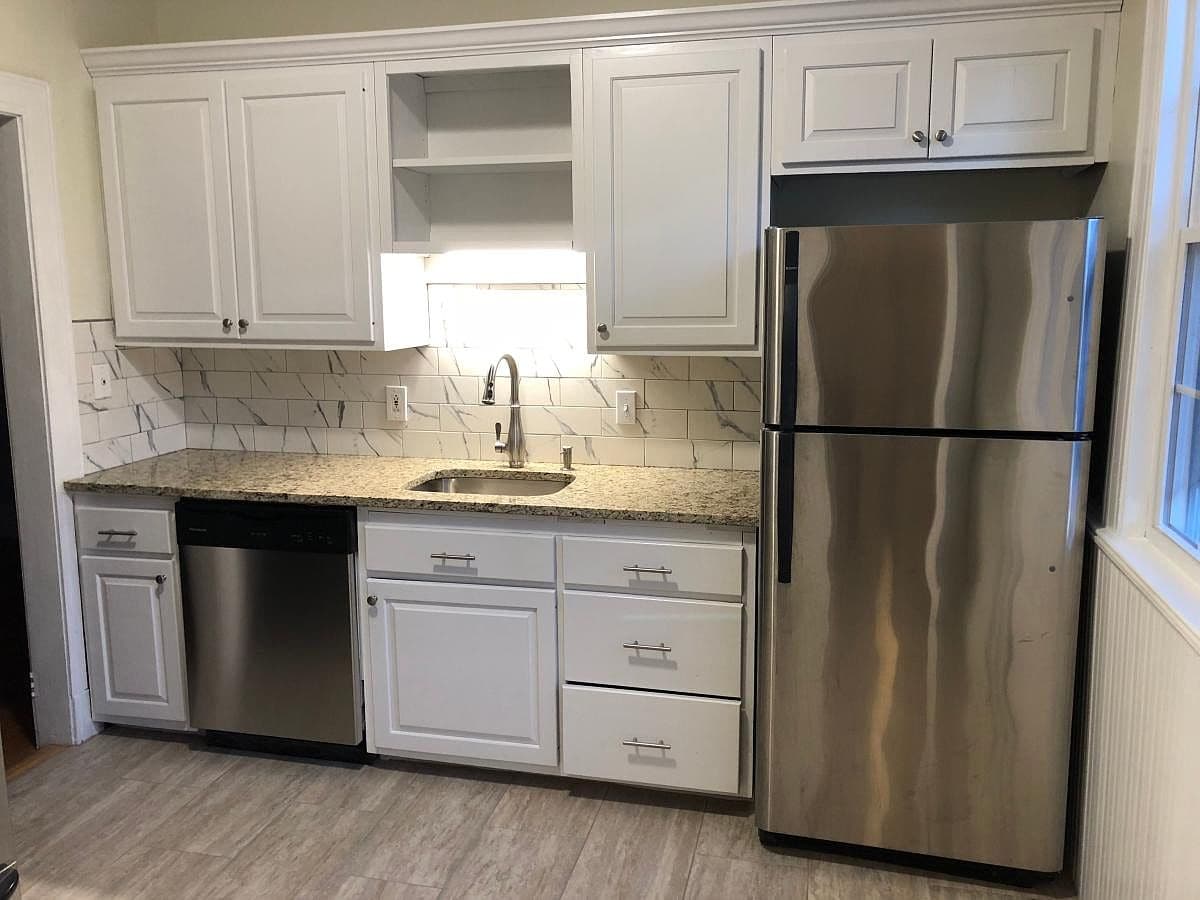Kitchen with white cabinets, granite counters, and stainless steel appliances in Apt A4 on Robin Rd.